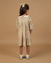 Early Sunday, Virginia Dress in Garden Flowers Cream, made from Printed Cotton Cambric fabric, featuring classic silhouette with embroidered collars, shown in a back view of model wearing it