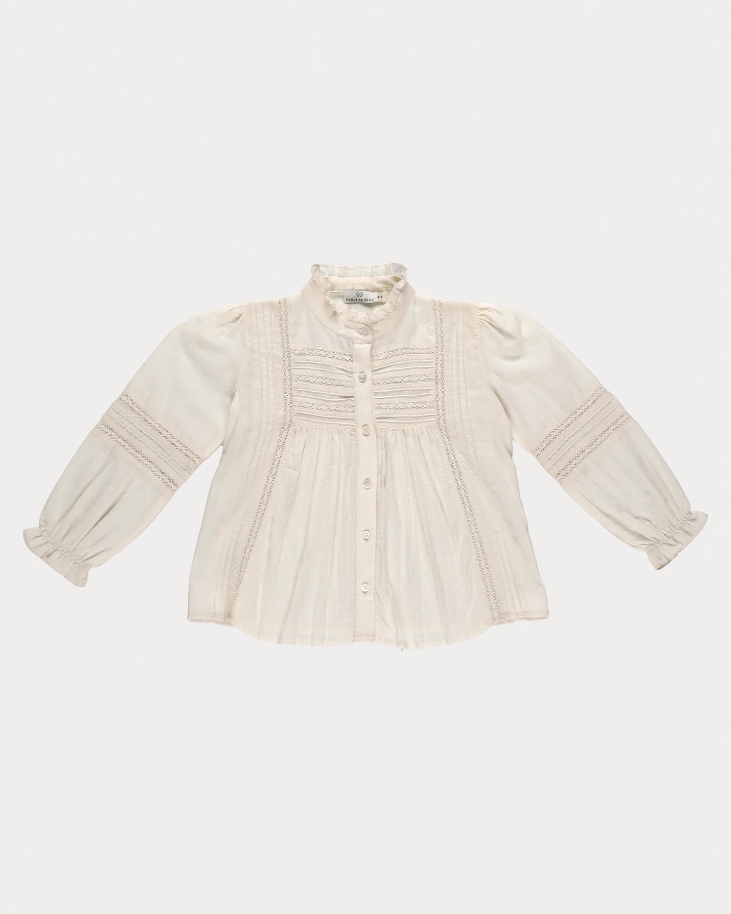 Early Sunday, Zoe Shirt in Ecru, made from Cotton Jeera Dobby Voile fabric, featuring frilled roundneck with detailed lace yoke, shown in a front flat-lay view