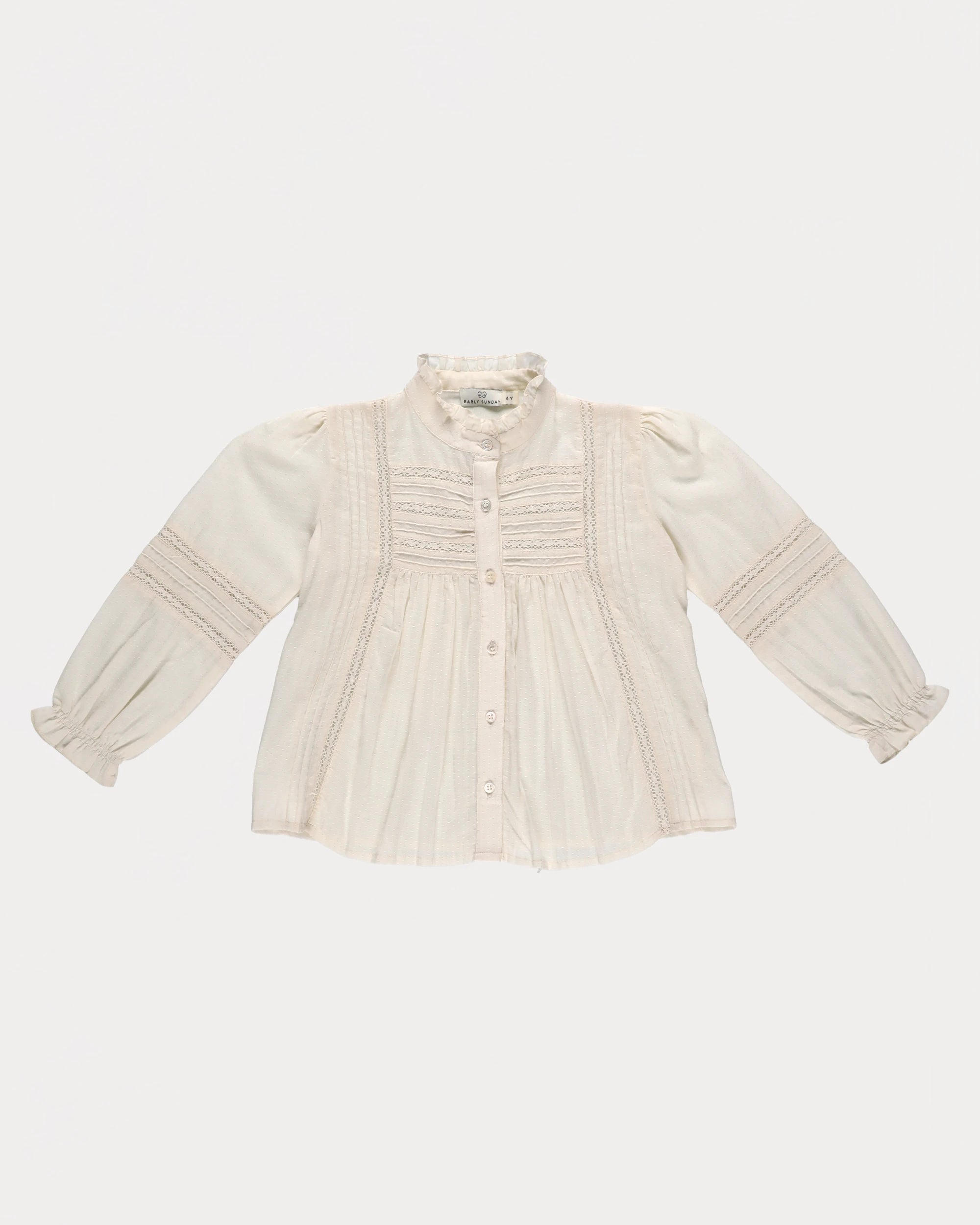 Early Sunday, Zoe Shirt in Ecru, made from Cotton Jeera Dobby Voile fabric, featuring frilled roundneck with detailed lace yoke, shown in a front flat-lay view