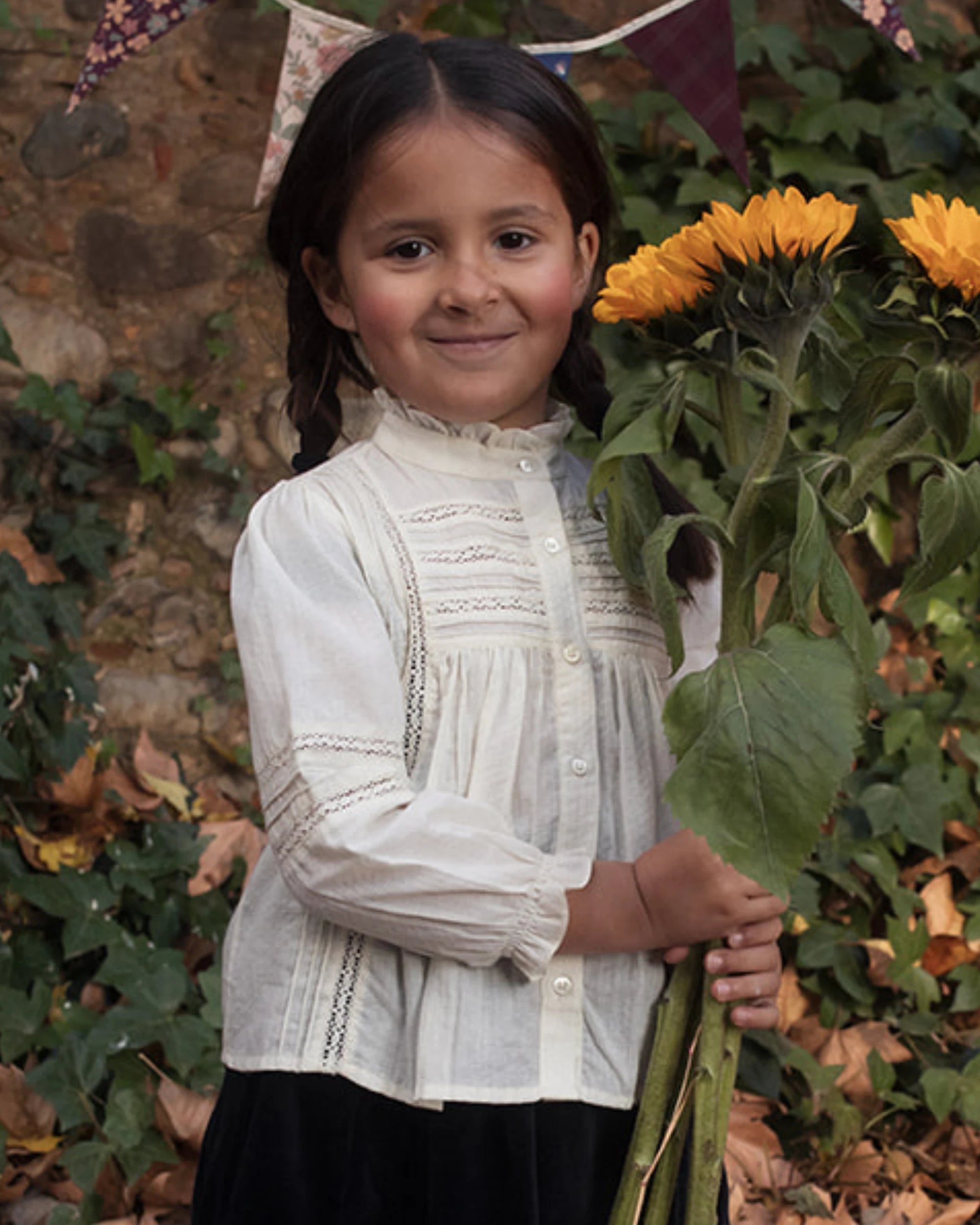 Early Sunday, Zoe Shirt in Ecru, made from Cotton Jeera Dobby Voile fabric, featuring frilled round neck with detailed lace yoke, shown in a front view of model wearing outdoors