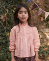 Early Sunday, Zoe Shirt in Nude, made from Cotton Jeera Dobby Voile fabric, featuring frilled roundneck with detailed lace yoke, shown in a front view of model wearing outdoors